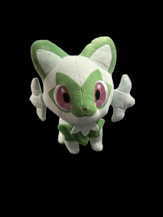 Plush toy of a green and white character with pink eyes on a black background